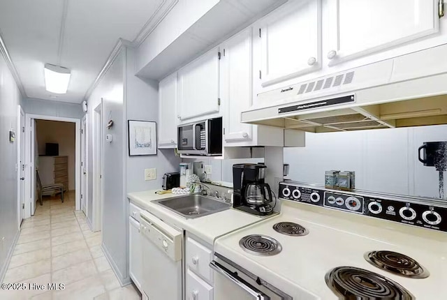 kitchen featuring a sink, light countertops, under cabinet range hood, white appliances, and white cabinetry