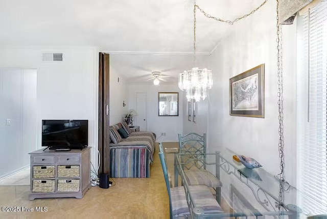 living area featuring tile patterned flooring, ceiling fan with notable chandelier, and visible vents