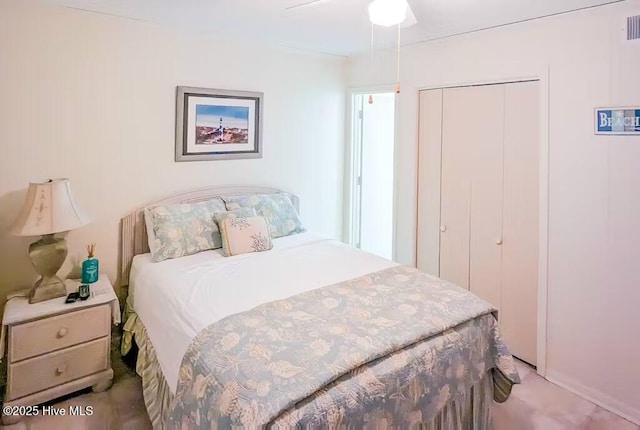 carpeted bedroom with ceiling fan, a closet, and visible vents