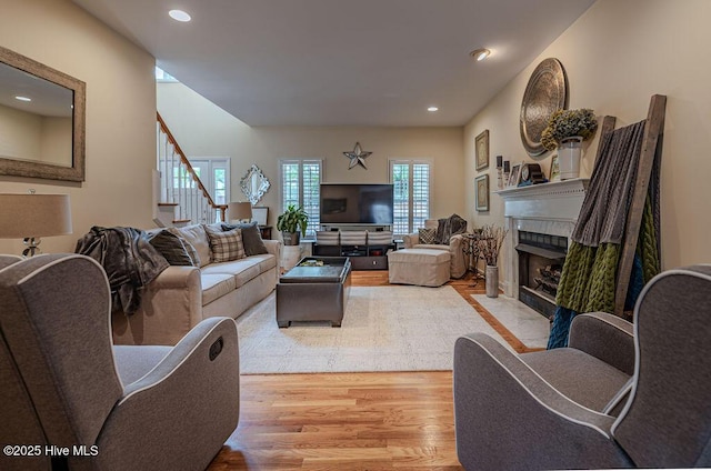 920 Diamondhead Dr S, Pinehurst, NC 28374 - living area featuring light wood-type flooring, a fireplace with flush hearth, recessed lighting, and stairway