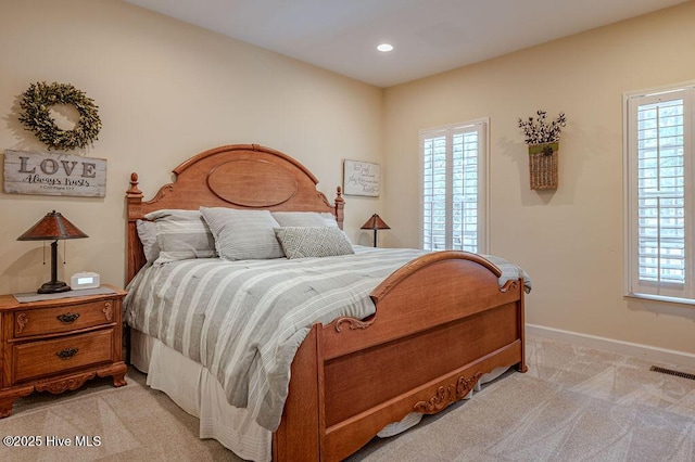 920 Diamondhead Dr S, Pinehurst, NC 28374 - bedroom with light colored carpet, baseboards, visible vents, and multiple windows