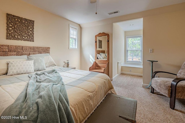 920 Diamondhead Dr S, Pinehurst, NC 28374 - carpeted bedroom featuring baseboards, multiple windows, ceiling fan, and visible vents