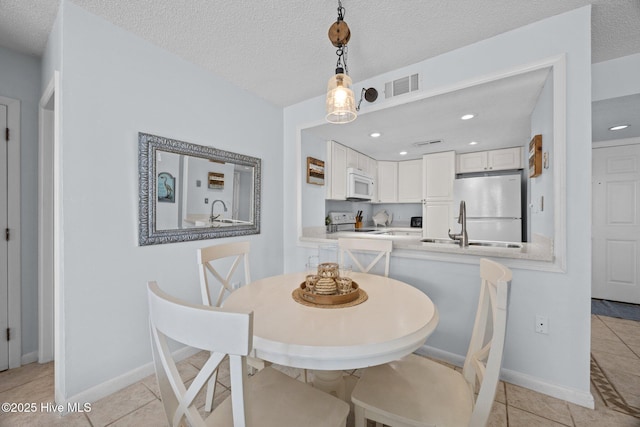 2000 New River Inlet Rd Unit 3302, North Topsail Beach, NC 28460 - dining space with light tile patterned flooring, recessed lighting, and a textured ceiling