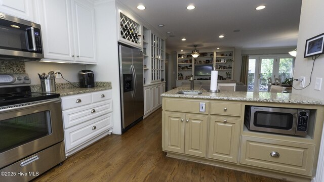 1914 Howard Ave, Tarboro, NC 27886 - kitchen with glass insert cabinets, a sink, appliances with stainless steel finishes, light stone counters, and recessed lighting