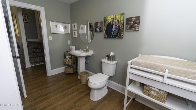 1914 Howard Ave, Tarboro, NC 27886 - bathroom with toilet, baseboards, and wood finished floors