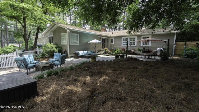 1914 Howard Ave, Tarboro, NC 27886 - rear view of property featuring a chimney, fence, a patio area, entry steps, and an outdoor living space with a fire pit