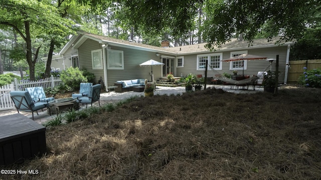 1914 Howard Ave, Tarboro, NC 27886 - back of house featuring fence, a patio, entry steps, a chimney, and an outdoor living space with a fire pit