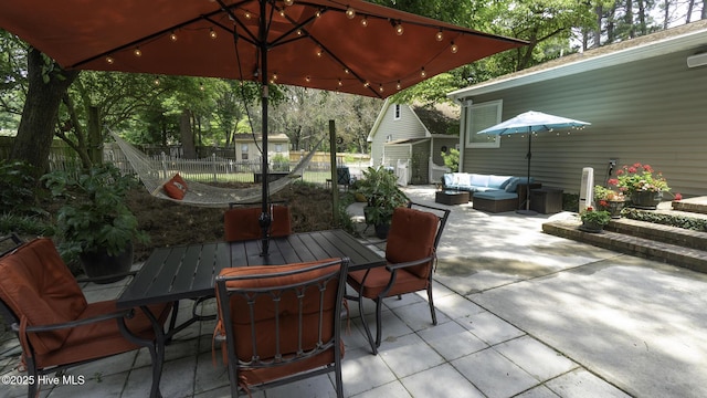 1914 Howard Ave, Tarboro, NC 27886 - view of patio featuring fence, a storage shed, an outdoor living space, an outbuilding, and outdoor dining area