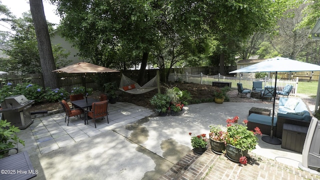 1914 Howard Ave, Tarboro, NC 27886 - view of patio featuring a fenced backyard, grilling area, an outdoor hangout area, and outdoor dining space