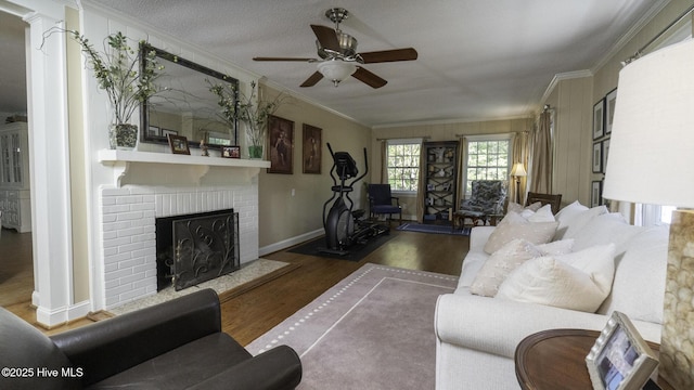 1914 Howard Ave, Tarboro, NC 27886 - living room with a ceiling fan, baseboards, a brick fireplace, crown molding, and wood finished floors