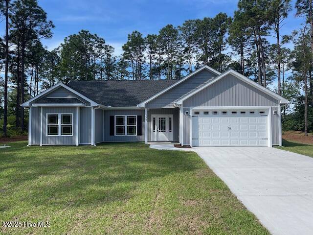 189 Boundaryline Dr NW, Calabash, NC 28467 - single story home with an attached garage, concrete driveway, and a front yard