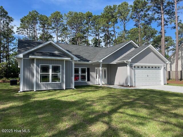 189 Boundaryline Dr NW, Calabash, NC 28467 - ranch-style home with a garage, a front yard, and driveway