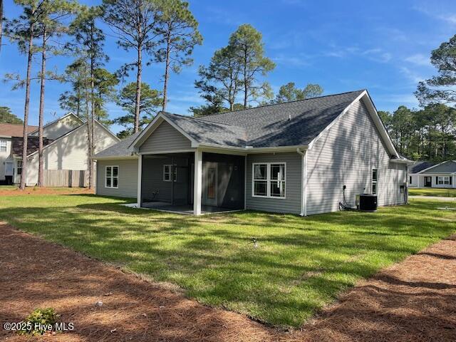 189 Boundaryline Dr NW, Calabash, NC 28467 - rear view of property featuring a sunroom, a yard, and central AC