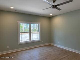 empty room featuring a ceiling fan, baseboards, recessed lighting, and wood finished floors