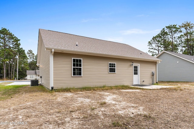 back of property featuring roof with shingles and central AC