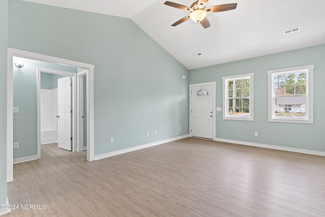unfurnished living room with ceiling fan, light wood-style floors, baseboards, lofted ceiling, and visible vents