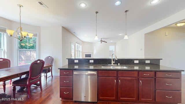 kitchen with dark brown cabinets, dark countertops, a sink, decorative light fixtures, and stainless steel dishwasher