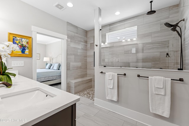 ensuite bathroom featuring vanity, ensuite bathroom, walk in shower, and recessed lighting