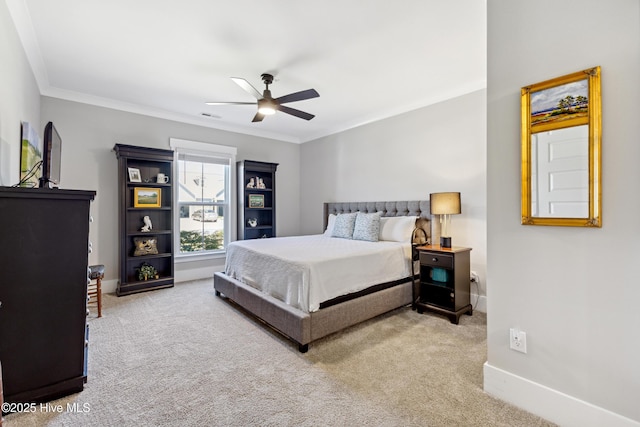 carpeted bedroom featuring baseboards, ornamental molding, ceiling fan, and visible vents