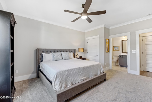 bedroom featuring ornamental molding, light carpet, baseboards, a ceiling fan, and ensuite bath