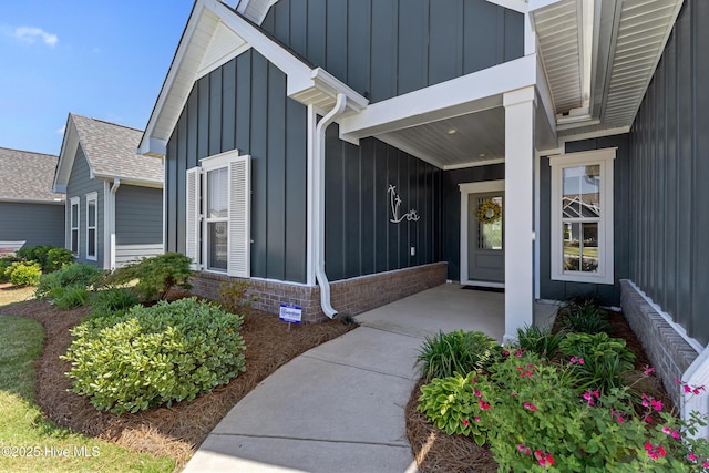view of exterior entry featuring board and batten siding