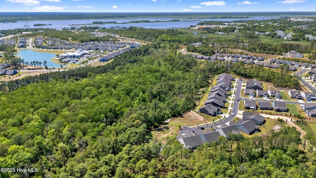 birds eye view of property with a water view, a residential view, and a wooded view