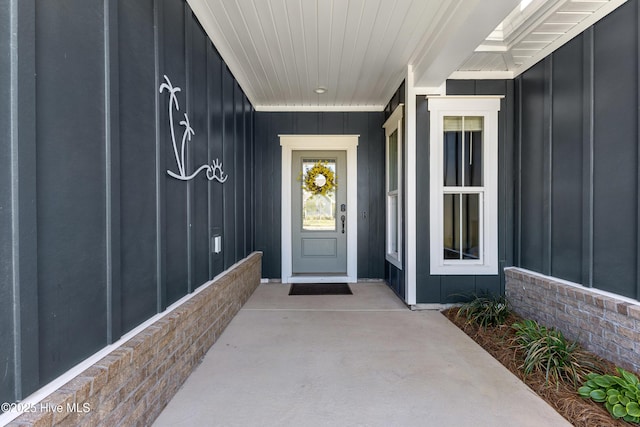 property entrance featuring board and batten siding
