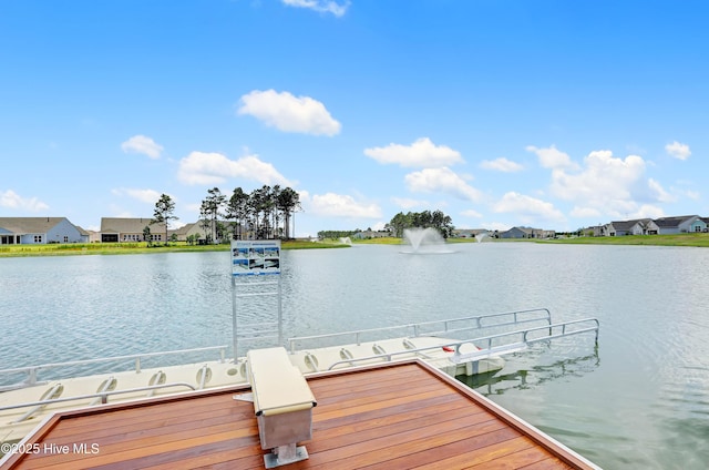 view of dock with a water view and a residential view