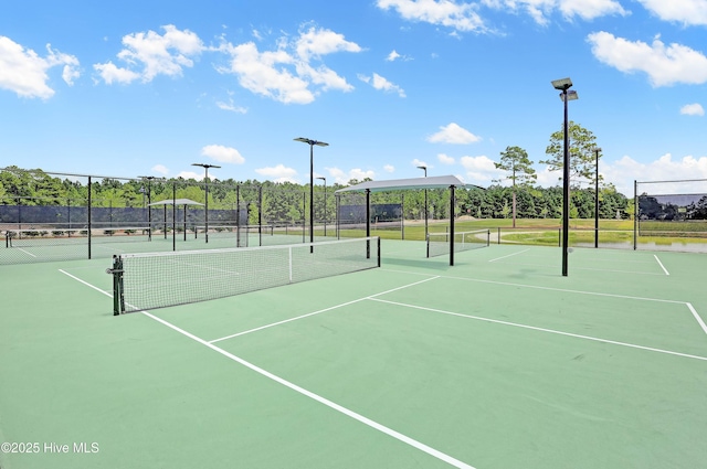 view of sport court featuring fence
