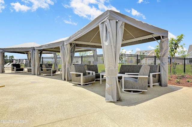 view of patio / terrace with a gazebo, fence, and an outdoor hangout area