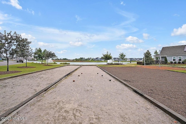 view of property's community featuring a water view and a yard