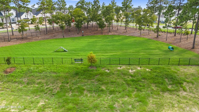view of yard with fence and a rural view