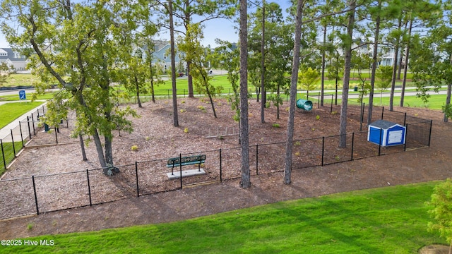 view of home's community with fence and a lawn