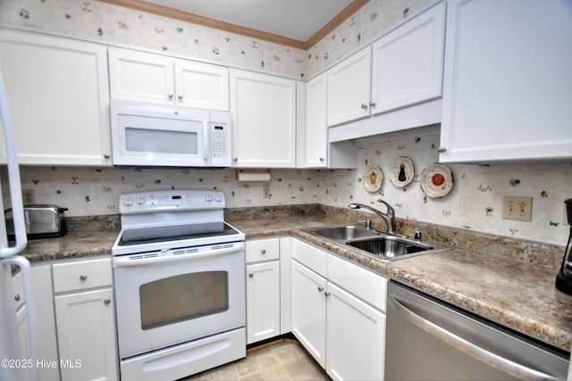 kitchen featuring white appliances, white cabinetry, ornamental molding, and a sink