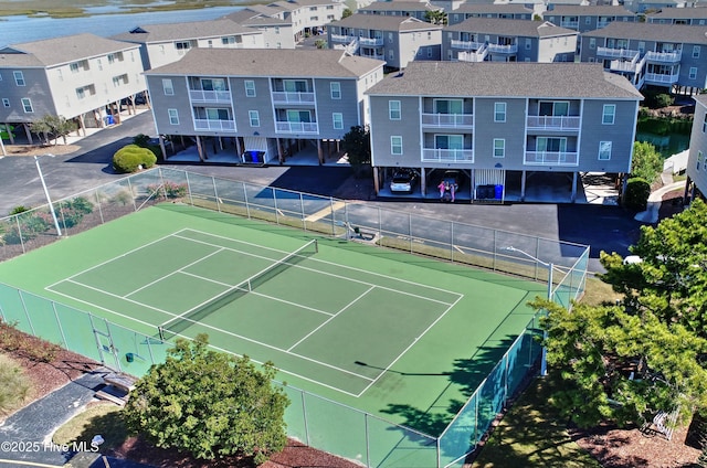 view of tennis court featuring fence