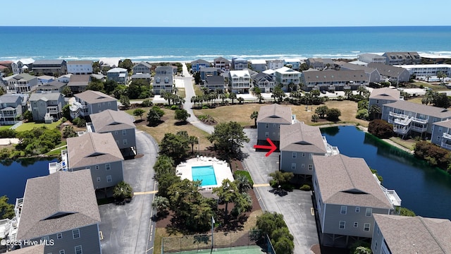 drone / aerial view featuring a residential view and a water view