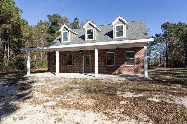 view of front of house with brick siding and a shingled roof