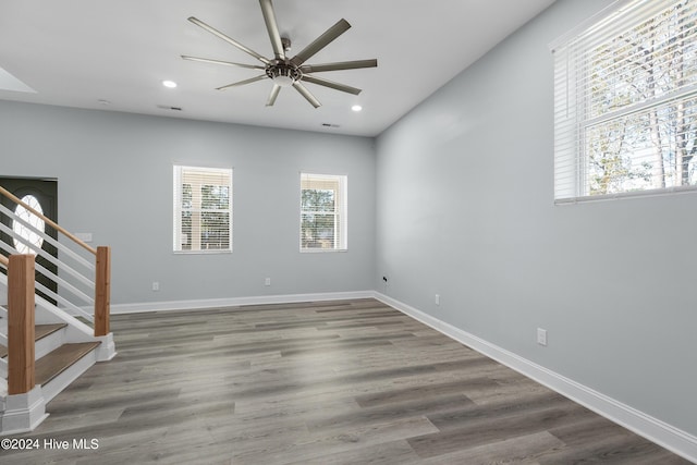 empty room featuring recessed lighting, a ceiling fan, stairs, and baseboards