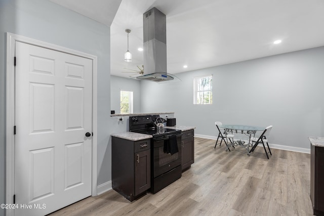 kitchen with island exhaust hood, black range with electric stovetop, baseboards, light wood finished floors, and recessed lighting