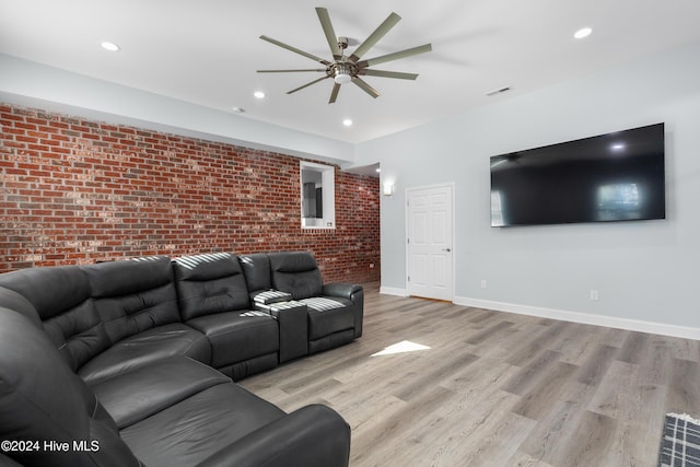 living area featuring recessed lighting, ceiling fan, light wood-type flooring, and brick wall