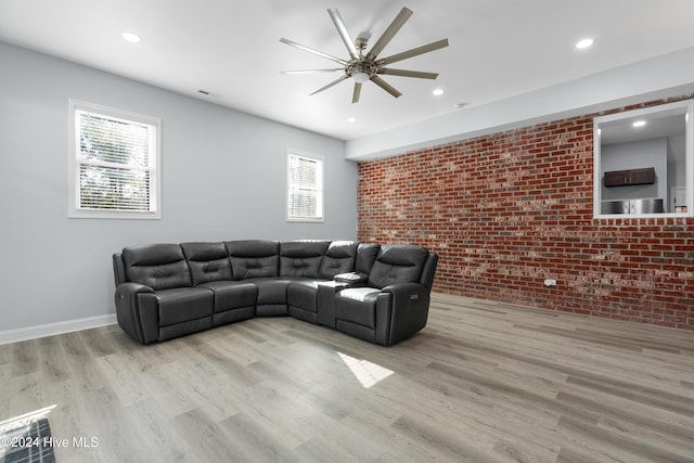 living area with ceiling fan, brick wall, recessed lighting, wood finished floors, and visible vents