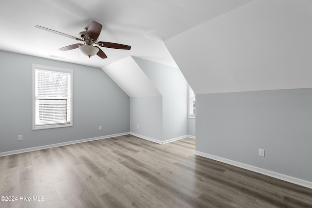 bonus room with a ceiling fan, wood finished floors, and a wealth of natural light