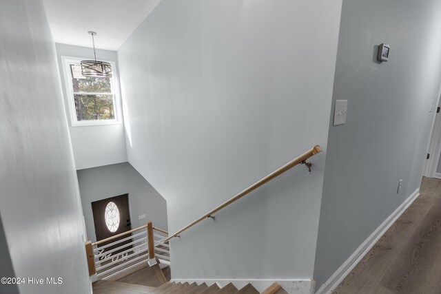 stairs with baseboards and wood finished floors