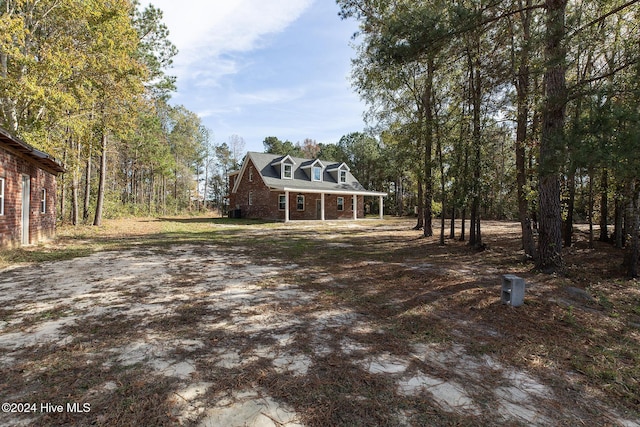new england style home with brick siding and covered porch
