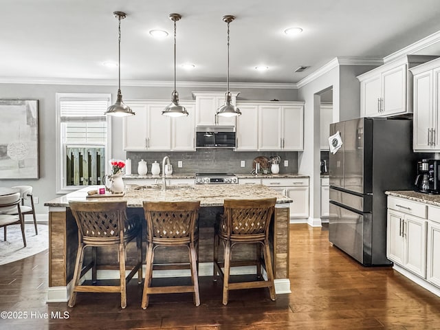 7845 Champlain Dr, Wilmington, NC 28412 - kitchen featuring white cabinets, appliances with stainless steel finishes, dark wood-style floors, and tasteful backsplash