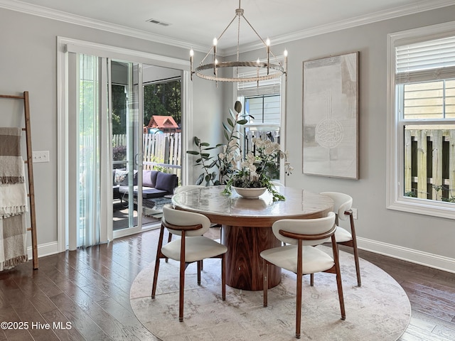 7845 Champlain Dr, Wilmington, NC 28412 - dining space with visible vents, baseboards, a notable chandelier, and hardwood / wood-style flooring