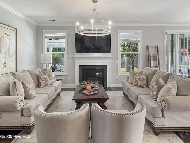 7845 Champlain Dr, Wilmington, NC 28412 - living room with crown molding, an inviting chandelier, wood finished floors, and visible vents