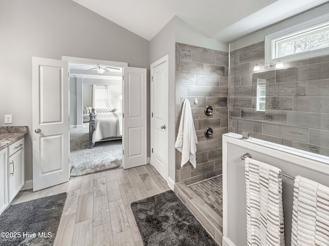 7845 Champlain Dr, Wilmington, NC 28412 - ensuite bathroom with wood finish floors, walk in shower, vanity, a ceiling fan, and vaulted ceiling