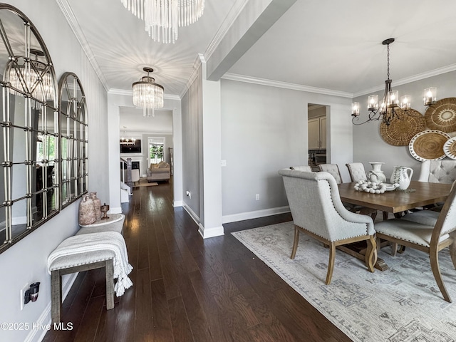 7845 Champlain Dr, Wilmington, NC 28412 - dining space featuring crown molding, baseboards, hardwood / wood-style flooring, and a chandelier