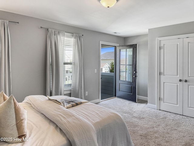 7845 Champlain Dr, Wilmington, NC 28412 - carpeted bedroom featuring baseboards, a closet, and access to exterior